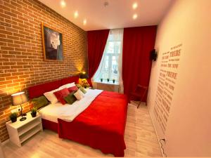 a bedroom with a large bed and a brick wall at CityComfort Hotel Kitay- Gorod in Moscow