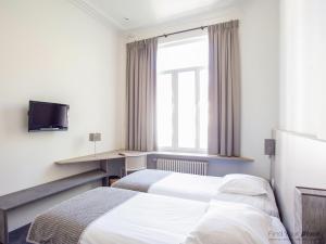Postel nebo postele na pokoji v ubytování Hotel Du Congres