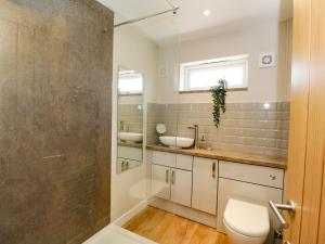 a bathroom with a toilet and a sink and a shower at Troopers Cottage in Frome +22 photos