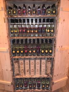 a refrigerator filled with lots of bottles of beer at Etno selo Milanovic - Nonac in Kuršumlija