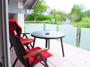 a patio with a table and chairs and a pool at Ferienwohnung Urban in Bestwig