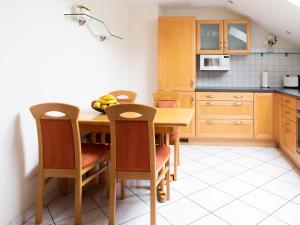 a kitchen with a wooden table and chairs at Ferienwohnung Urban in Bestwig