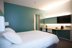 Postel nebo postele na pokoji v ubytování Hotel Du Congres