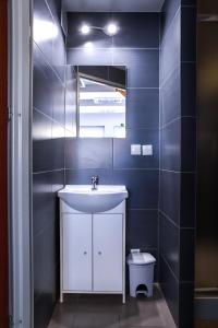 a bathroom with a sink and a toilet at Apartamenty Mazury Kamienica Centrum in Mrągowo