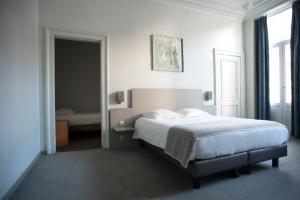 Postel nebo postele na pokoji v ubytování Hotel Du Congres