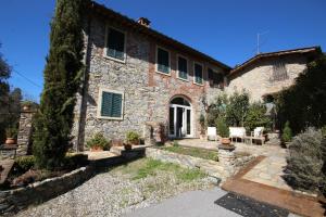 a large stone house with a patio in front of it at Relais Victoria B&B in San Macario In Piano