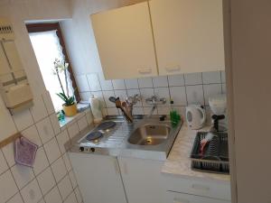 a small kitchen with a sink and a window at Ferienhaus Scheffler in Saal
