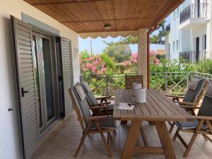 a wooden table and chairs on a patio at Evdokia Suites in Gouves