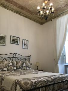 a bedroom with a bed with a chandelier at B&B Lercari in Genoa