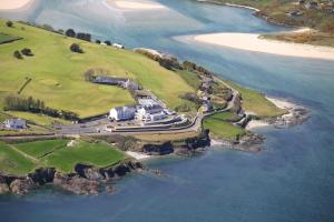 an aerial view of a house on an island in the water at Dunmore House Hotel in Clonakilty