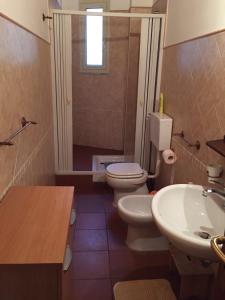 a bathroom with two toilets and a sink and a shower at Casetta Mondello in Mondello
