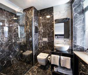 a bathroom with a toilet and a sink at Taksim Seya Suites Hotel in Istanbul +39 photos