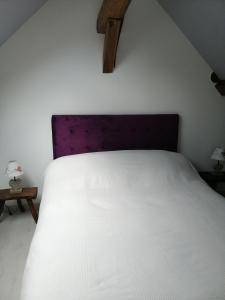 מיטה או מיטות בחדר ב-Gîte Les Bauvans