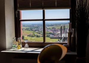 a window with a view of a city through it at Hotel Zum Burggraf in Neuleiningen