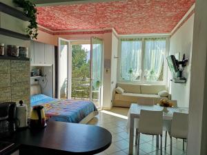 a bedroom with a bed and a table with a dining room at Garda Apartments in Euroresidence in Garda