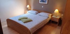a bedroom with a bed with two pillows on it at Apatmani Milena in Opatija
