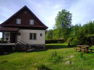 a small house with a picnic table in the yard at Villa Ester in Tatranská Lomnica