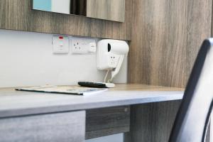 a hair dryer on a counter in a room at Beach Garden Hotel in St Julian's