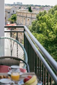 a table with a plate of food on a balcony at Vista center Apartment in Pula