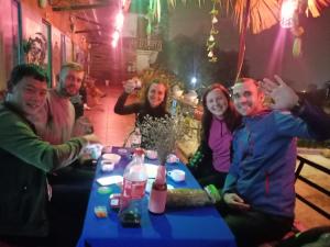 a group of people sitting around a table at Sapa Tatu Homestay in Sa Pa