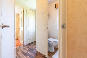 a bathroom with a toilet and a door open at Ubytování v Lednici in Lednice +29 photos