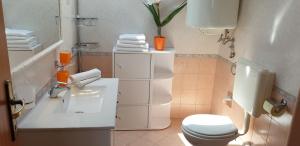 a white bathroom with a toilet and a sink at Apatmani Milena in Opatija +24 photos