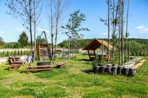 a park with a playground and a swing at Apartamenty Mazury in Mrągowo