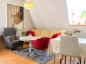 ein Wohnzimmer mit einem Sofa, einem Tisch und Stühlen in der Unterkunft Hello Apartments COZY & ART VIBES Targ Rybny in Danzig