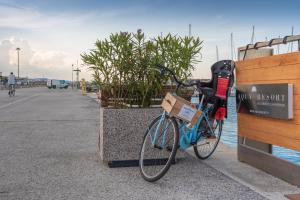 a bike parked on a sidewalk next to a fence at AQUA RESORT GIULIANOVA - Houseboat Experience in Giulianova