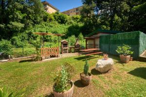 a yard with potted plants and a picnic table at Casa della nonna in Abbadia Lariana