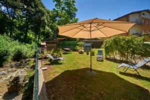 a large umbrella sitting in the middle of a yard at Casa della nonna in Abbadia Lariana