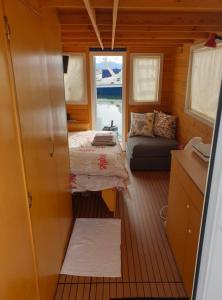 a small room with a bed and a couch at HouseBoat Cagliari in Cagliari