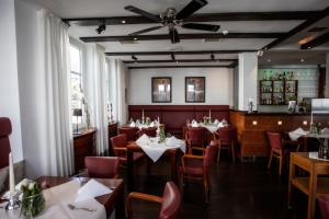 a restaurant with tables and chairs and a ceiling at Hotel zur Post in Brilon