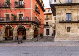 a group of buildings with balconies on a street at Housingleón - Nama Plaza Mayor in León