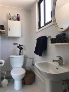 a bathroom with a white toilet and a sink at Sweet n’ Boujee Studio Apartment with Varenda in Paphos City