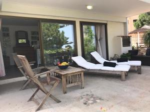 a patio with two chairs and a couch and a table at Sweet n’ Boujee Studio Apartment with Varenda in Paphos City
