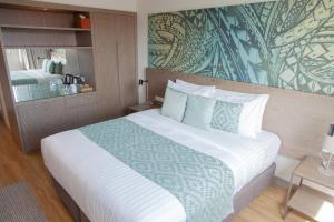 a bedroom with a large white bed in a room at Lava Hotel in Apia