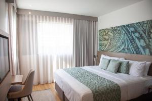 Ένα ή περισσότερα κρεβάτια σε δωμάτιο στο Lava Hotel