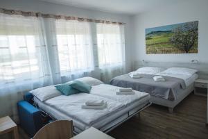 A bed or beds in a room at Apartmány Pemag Mikulov