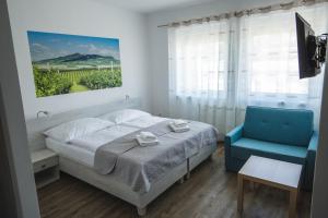 A bed or beds in a room at Apartmány Pemag Mikulov