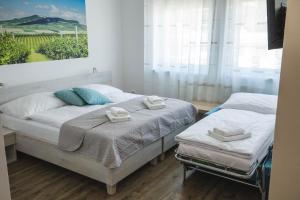 A bed or beds in a room at Apartmány Pemag Mikulov