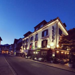 a building on the side of a street at night at Esos Hotel Quelle in Bad Ragaz
