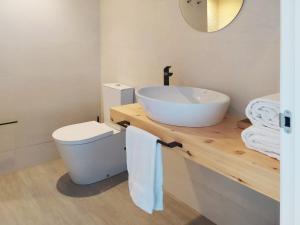 a bathroom with a sink and a toilet at Mar do Ézaro - Boutique Hotel in Ézaro