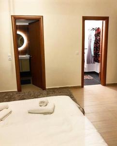 a bedroom with a white bed and a closet at La Vatura in Gialova