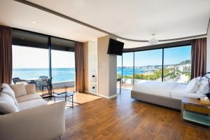 a bedroom with a bed and a view of the ocean at Yacht Hotel in Vlorë