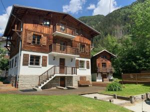 a large wooden house with a porch and a balcony at 4 Bedroom, 4 Bathroom, Hot Tub, Chamonix Centre in Chamonix-Mont-Blanc