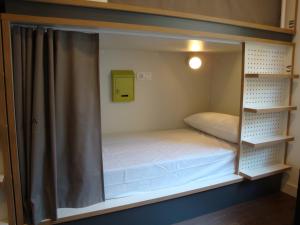 A bed or beds in a room at Agora Hostel