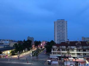 a city street at night with a tall building at Hotel Atol in Sunny Beach