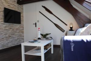 a living room with a white table and a tv at CHERBOURG MARITIME in Cherbourg en Cotentin