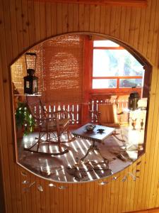 a room with a table and a chair and a mirror at Country house Todor in Kragujevac